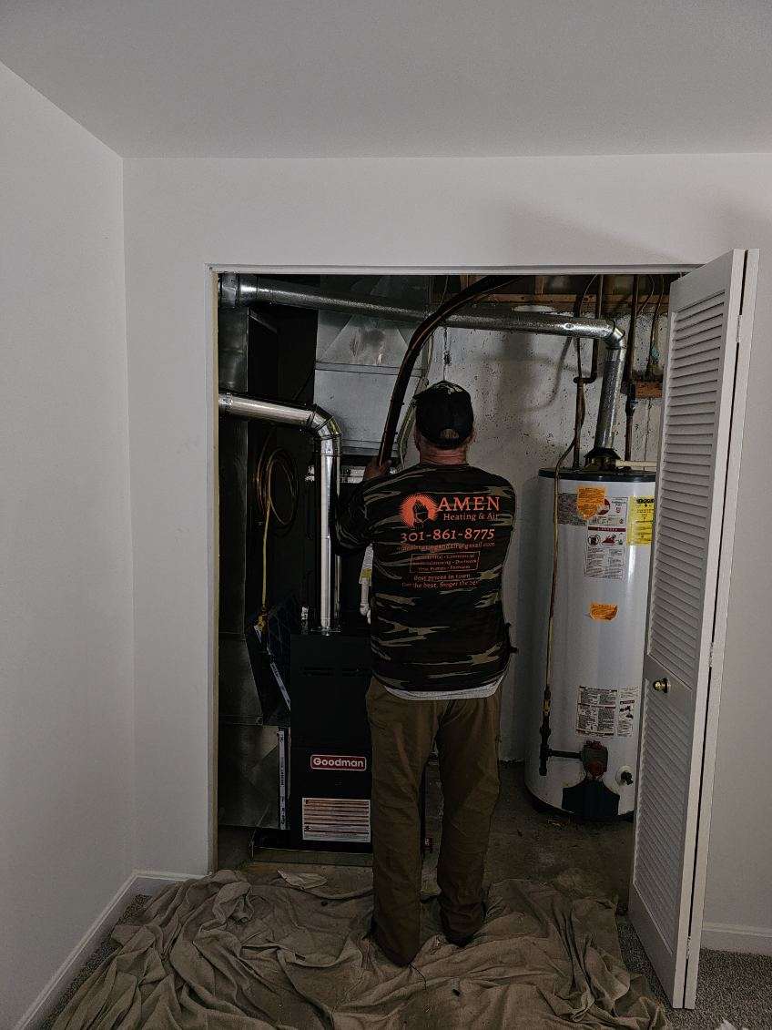 Amen HVAC technician servicing a Goodman furnace in a Maryland home